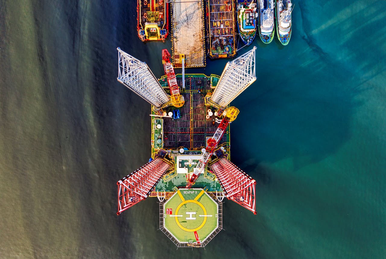 Stunning aerial view of a vibrant offshore oil rig with crane and helipad in Jakarta